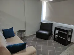 Sala de terapia com sofá e poltrona